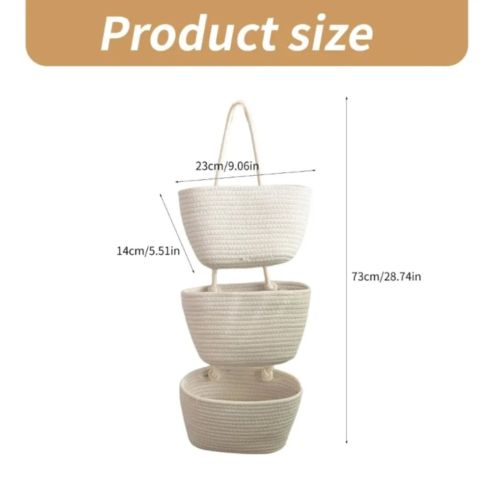 A stack of three handwoven white wicker storage baskets shown against a white background.