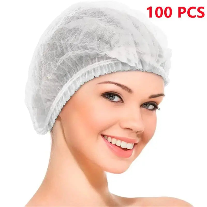 A close-up of a woman wearing a white disposable bouffant hair net cover.