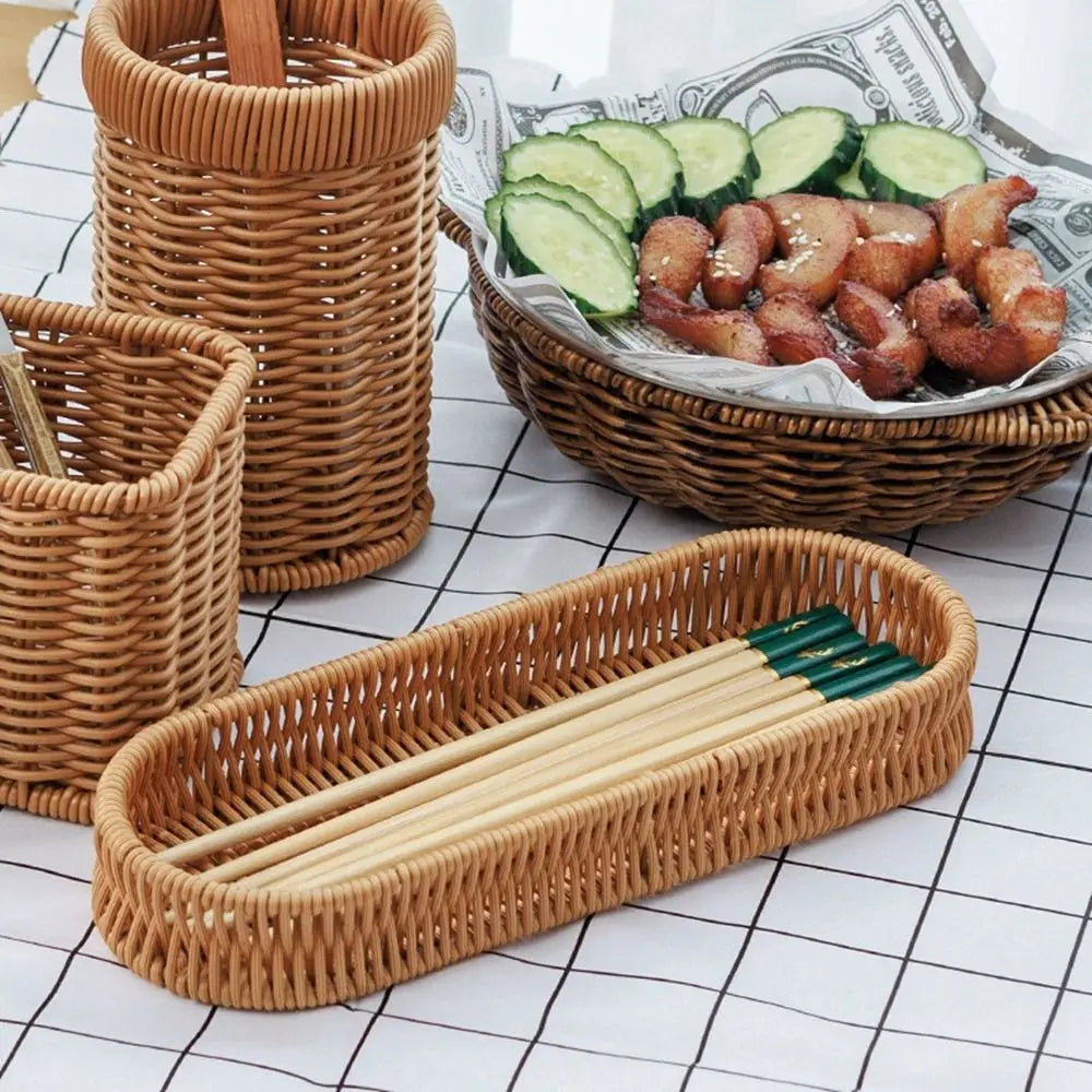 Handwoven rattan serving baskets holding food and chopsticks on a white checkered surface