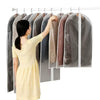 A woman is hanging a garment on a hanger that has a dust cover, showing the fabric and its protective sleeve.