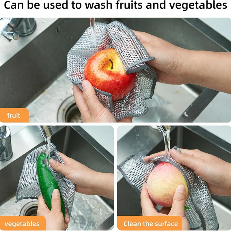 Hands are using stainless steel wire dish cleaning cloths to wash fruits and vegetables in a kitchen sink.