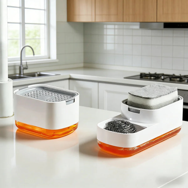 A white countertop soap dispenser with an orange base and a removable sponge holder is shown on a kitchen counter.