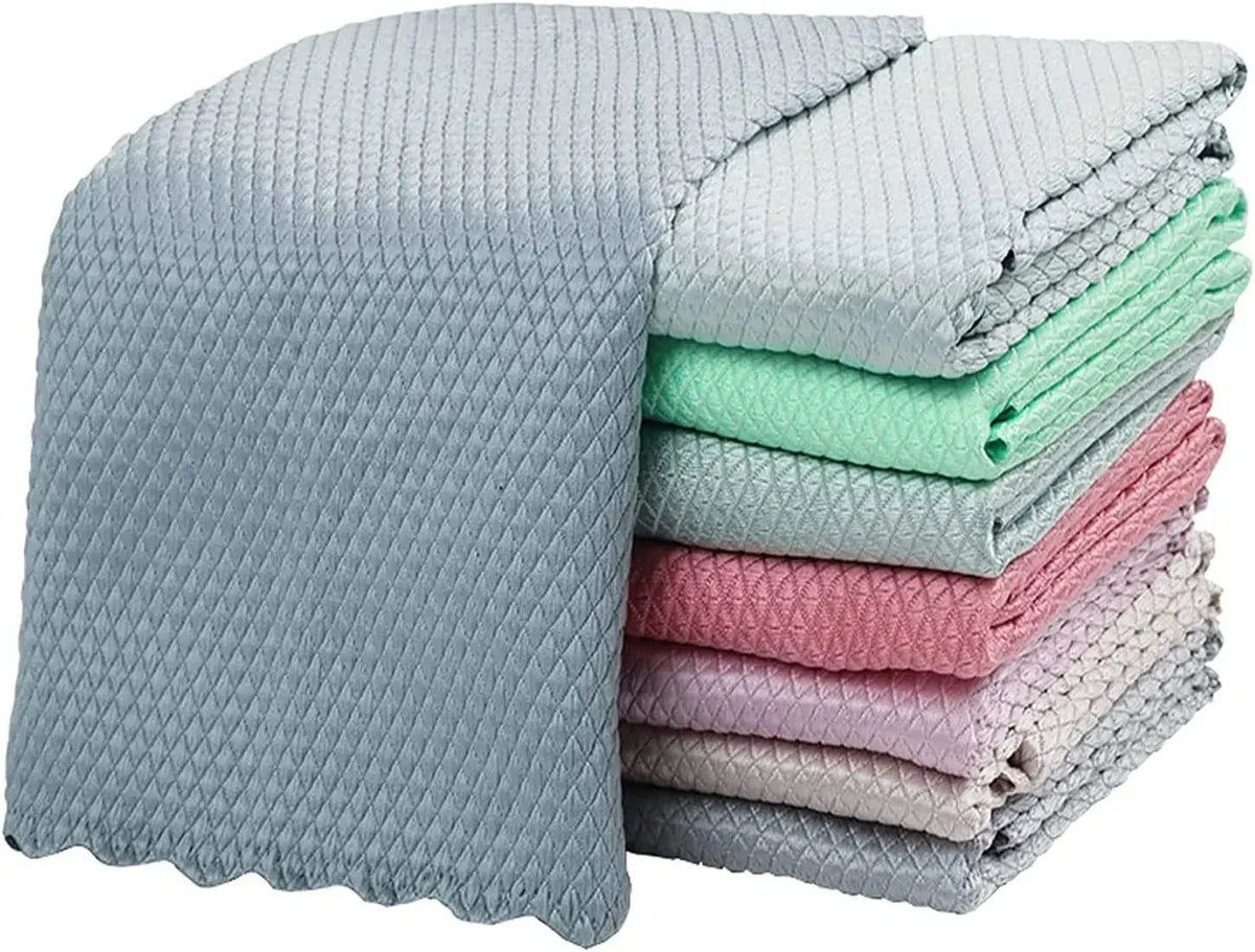 Ein Stapel wiederverwendbarer Mikrofasertücher in verschiedenen Pastellfarben wie Grau, Mintgrün und Rosa.