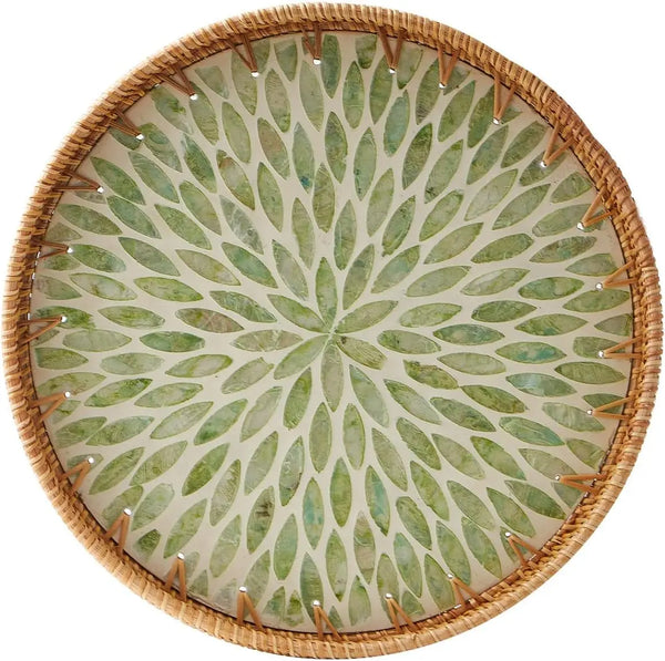 Round rattan serving tray with mother of pearl inlay featuring a green leaf pattern.