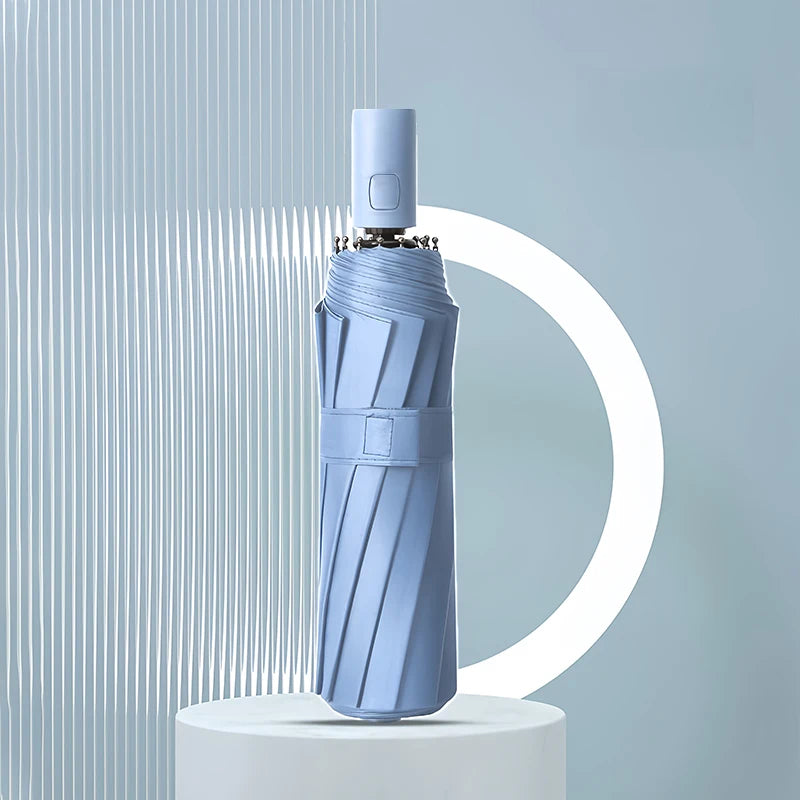 A light blue heavy duty automatic windproof umbrella standing upright against a light gray background.