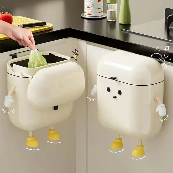A white cartoon-shaped hanging trash can with a lid is displayed on a cabinet door.