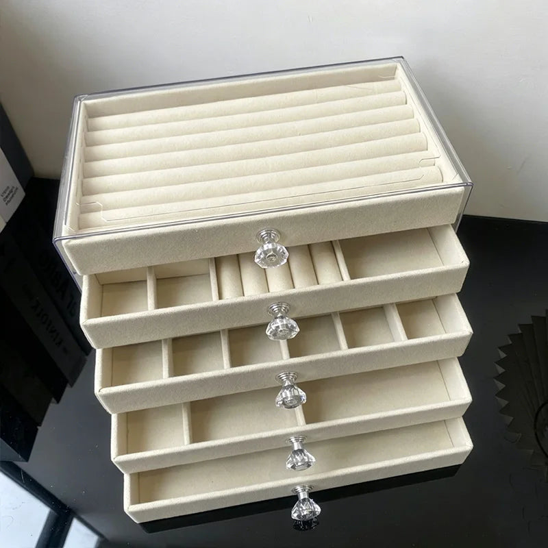 A light beige 5-tier desktop jewelry organizer rack with clear acrylic compartments.