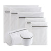 A stack of four white fine mesh laundry bags for delicate clothing, some closed and one open.