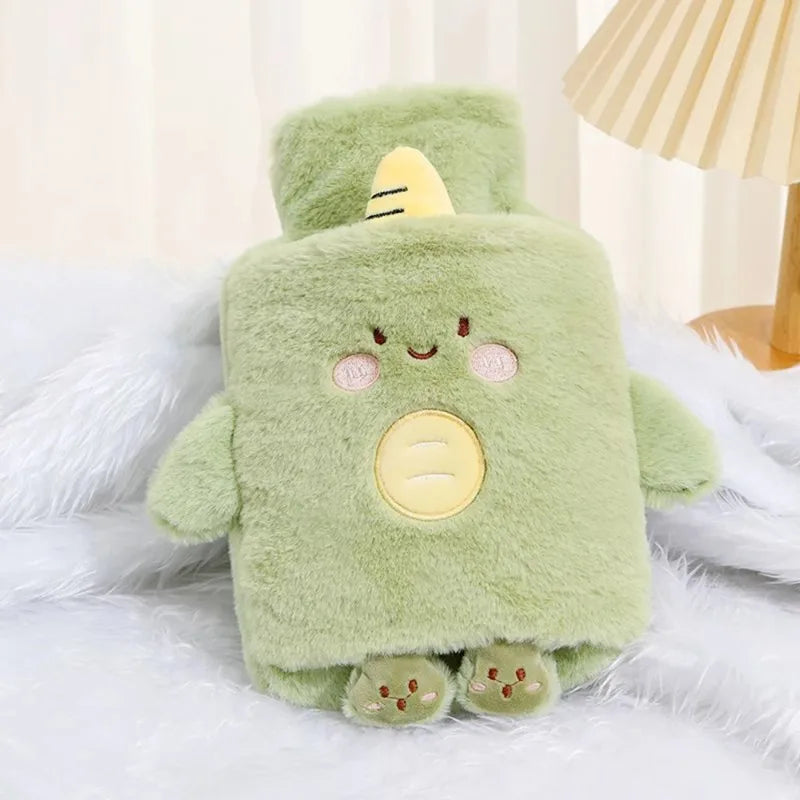 A soft green plush animal hot water bottle with a yellow horn and pink accents resting on white fur.