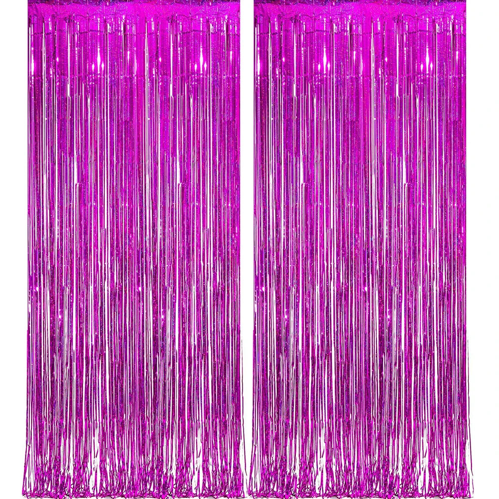 A vibrant magenta foil tinsel fringe curtain backdrop set with vertical strands.