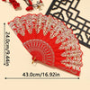 A vibrant red and gold embroidered folding hand fan displayed against a light background.