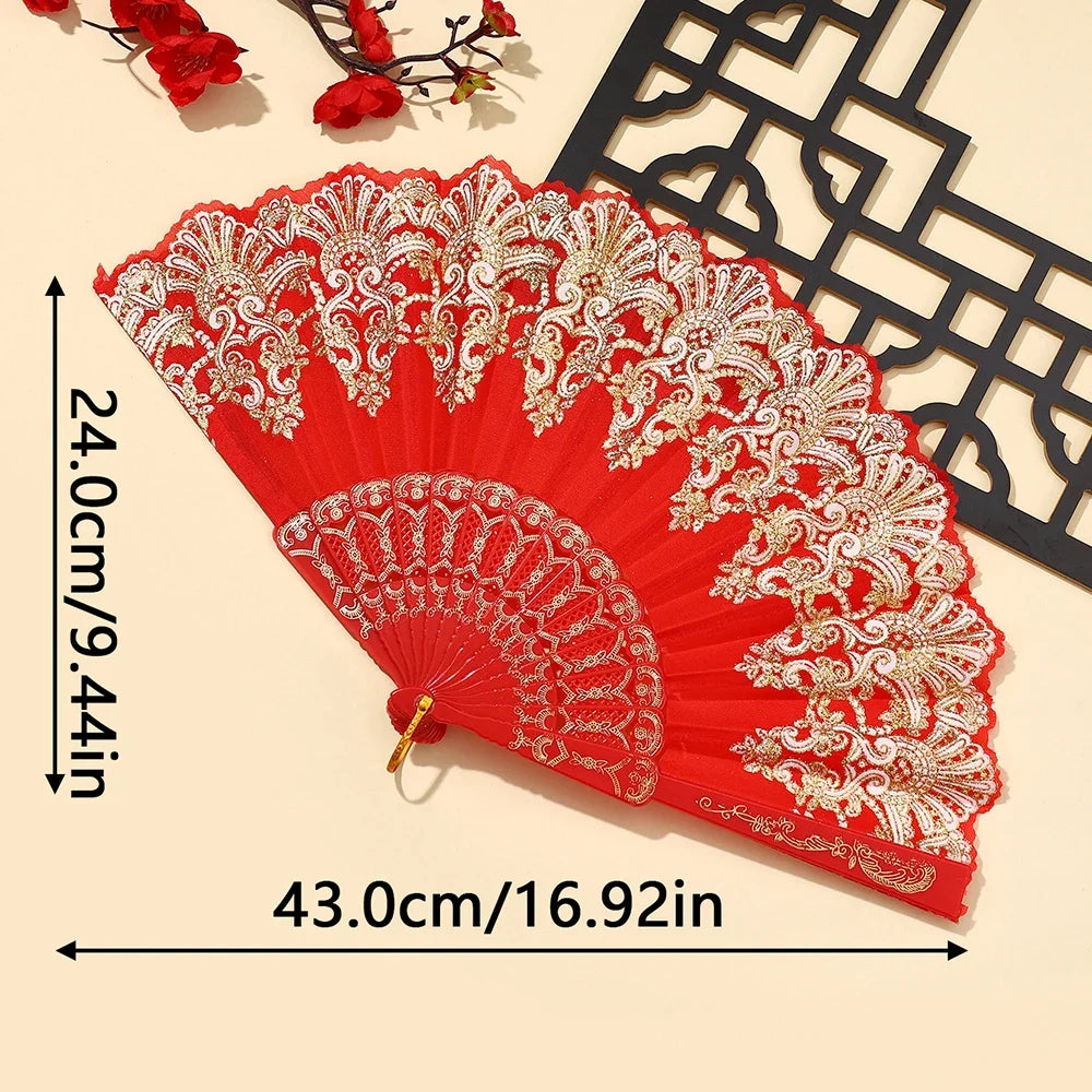 A vibrant red and gold embroidered folding hand fan displayed against a light background.