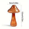 A translucent amber glass mushroom vase with a flared cap and narrow neck, shown against a white background.