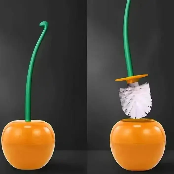 A decorative cherry-shaped toilet brush set with a green handle and orange base.