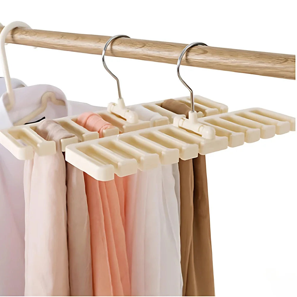 A wooden hanger with multiple plastic slots is hanging on a wooden rod, used for organizing belts and ties in a closet.