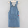 A denim apron with a bib front and patch pocket is displayed on a hanger.