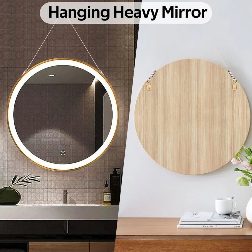 A round mirror with a gold frame is hanging on a wall above a dark countertop.