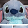 Close-up of a light blue cartoon anime plush toy with large eyes and a blue nose.