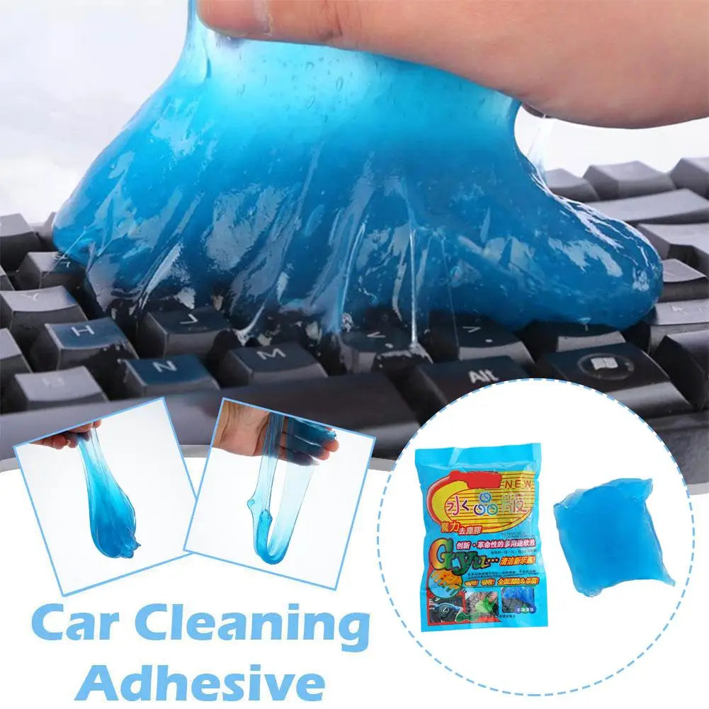 A hand is applying a blue cleaning gel onto a keyboard, demonstrating the Car Cleaning Adhesive product.