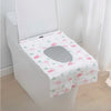 A white toilet seat covered with a pink flamingo patterned disposable printing seat cover.
