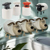A set of decorative toilet paper holders shaped like cats and dogs in various colors