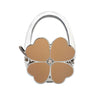 Silver foldable handbag hook with a flower-shaped leather accent and a small clear stone.