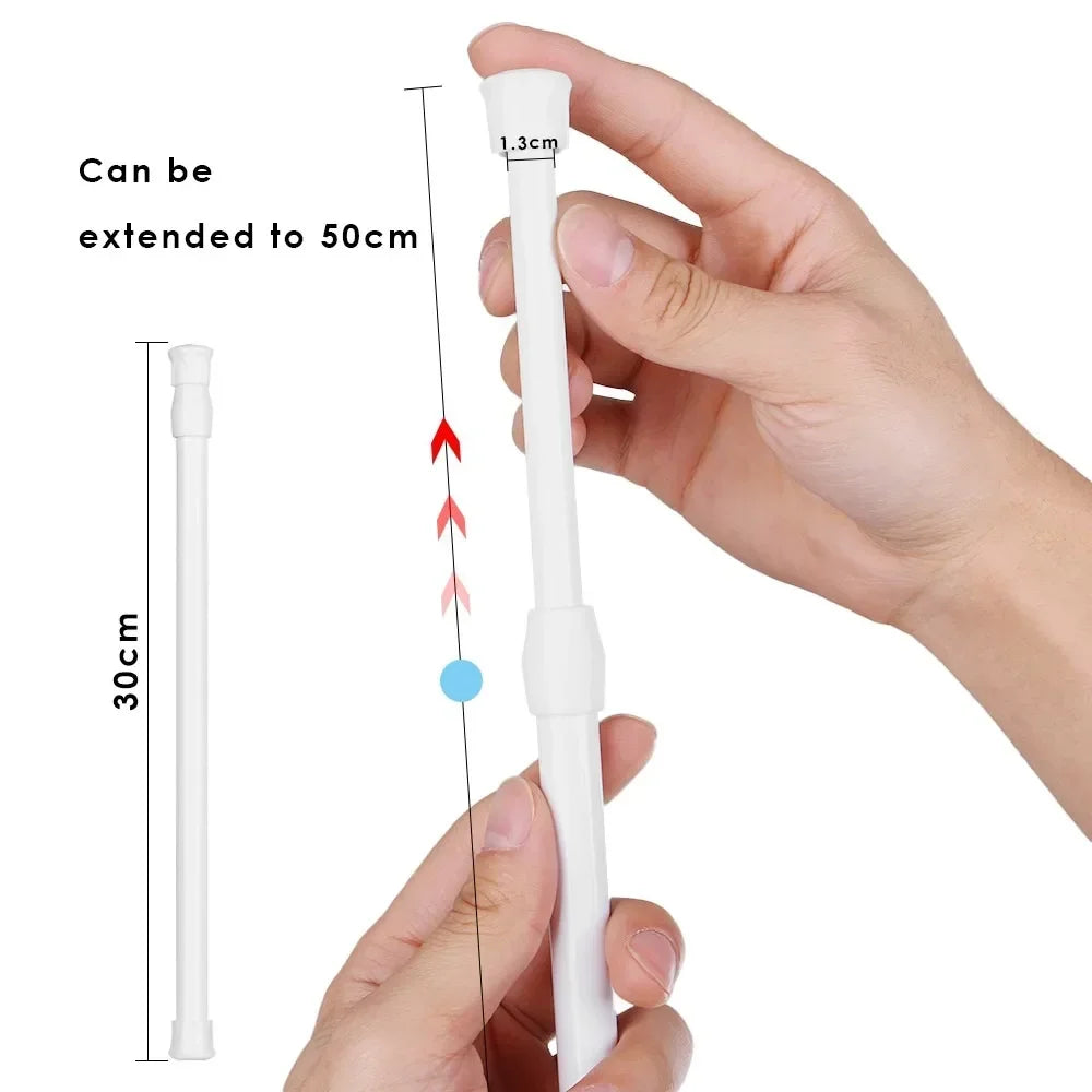 A hand holds an adjustable telescopic curtain rod, showing its length and extension capability.