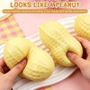 A yellow peanut-shaped squishy toy is being held by hands on a white tray.