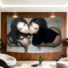 A large canvas banner featuring two women with dark hair posing closely against a neutral background.