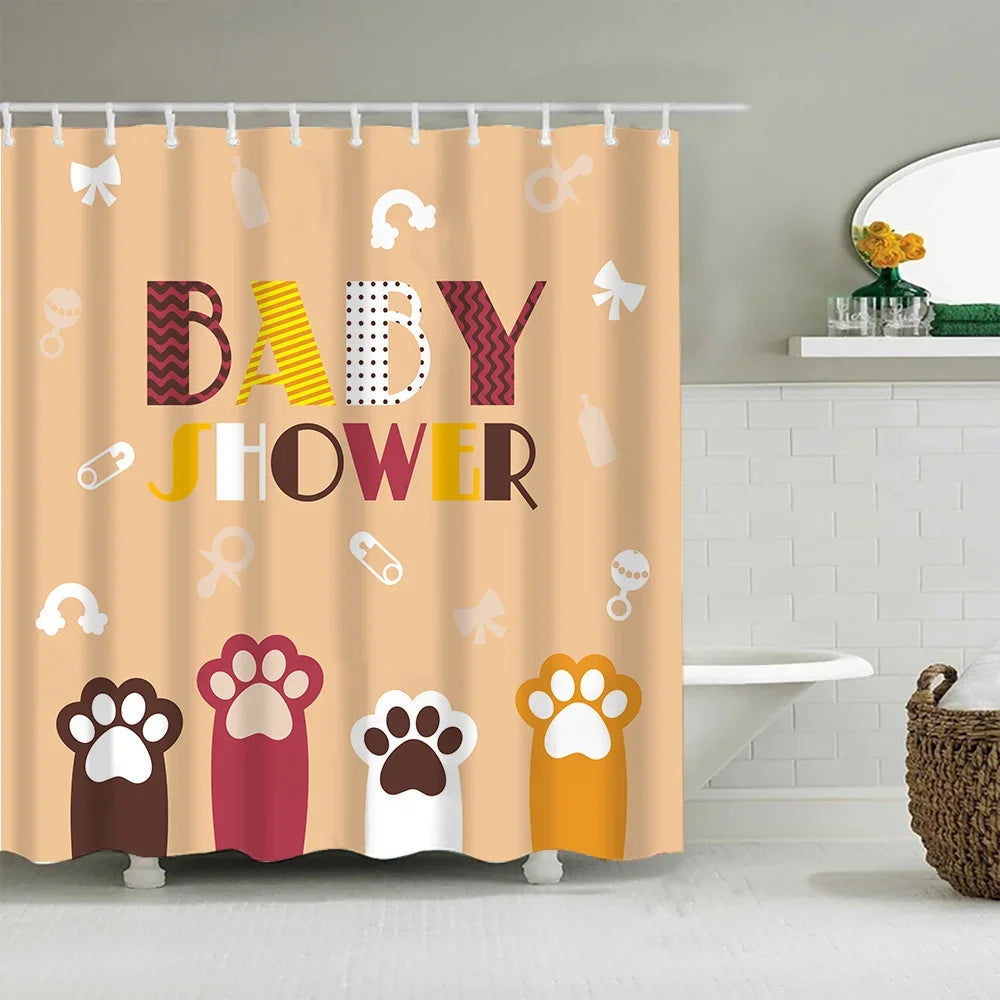 A shower curtain featuring colorful cartoon paw prints and baby shower text on a beige background.