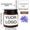 A dark glass jar with a black lid featuring a white logo and a customization area, labeled for a custom photo scented soy can