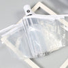 A white automatic transparent folding umbrella is shown folded within a light wooden frame.