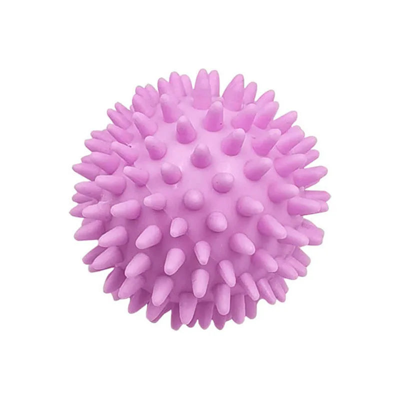 A pink reusable laundry ball with a textured, spherical surface.
