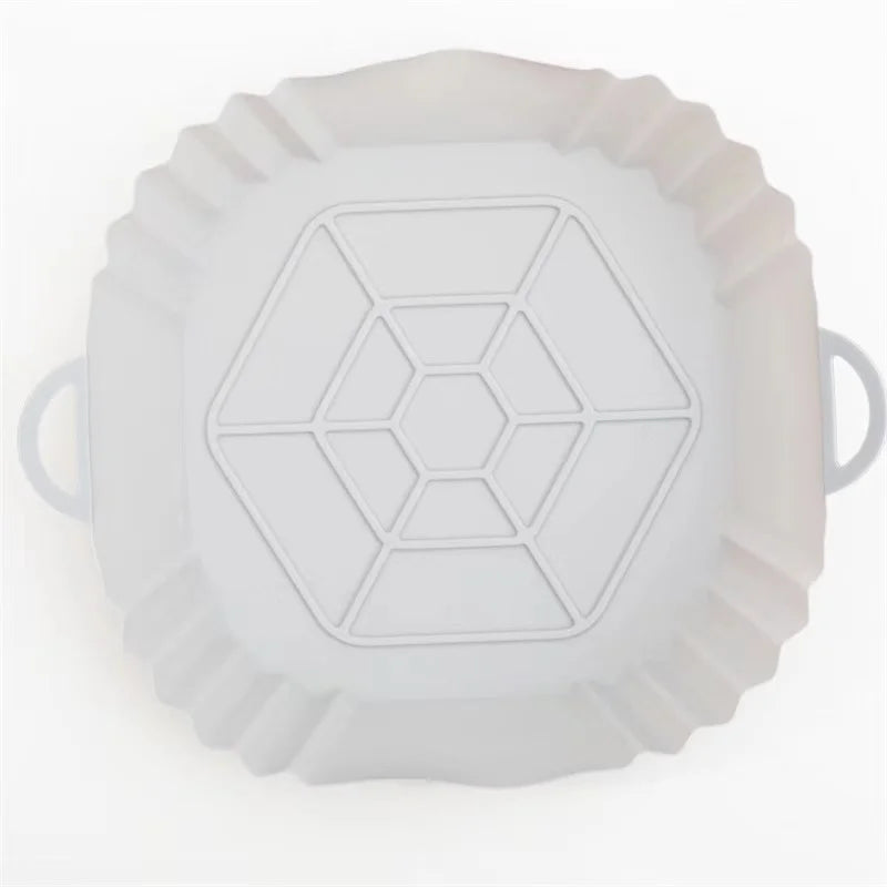 A white reusable silicone air fryer liner with a geometric pattern.
