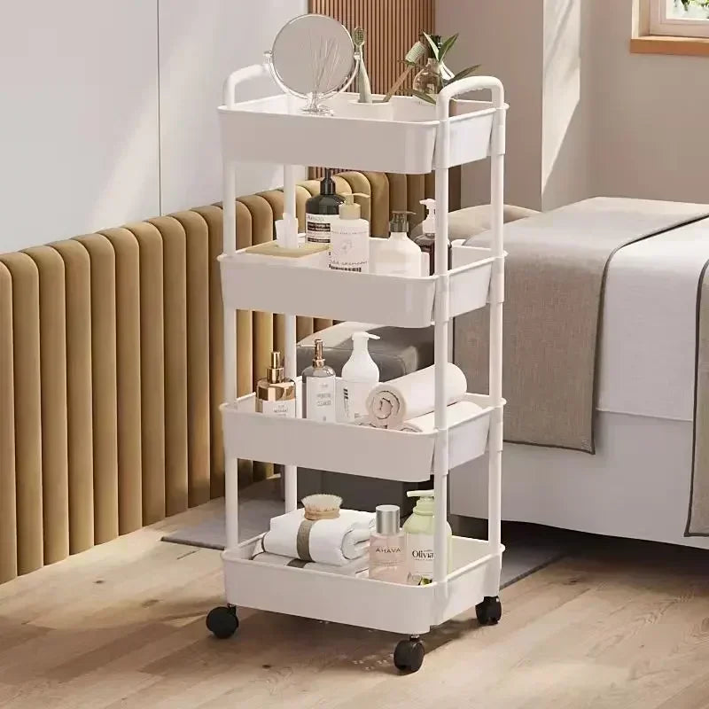 A white multi-tier rolling storage rack with various bathroom and vanity items is shown in a bright room.