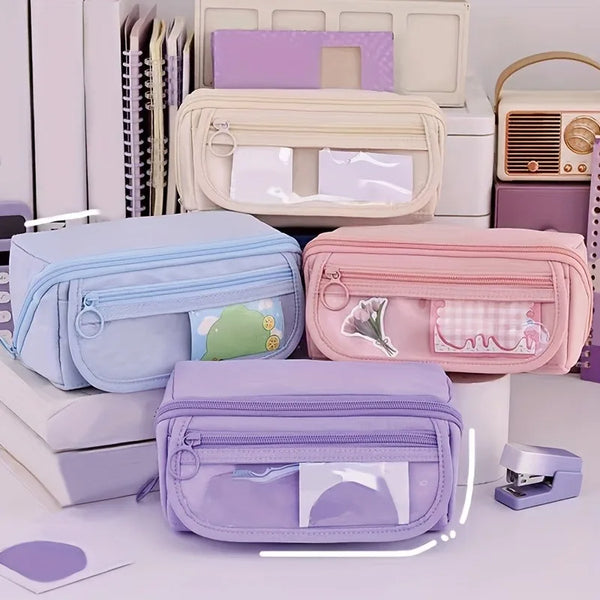 A collection of pastel-colored multi-compartment pencil cases and organizers for desk storage.