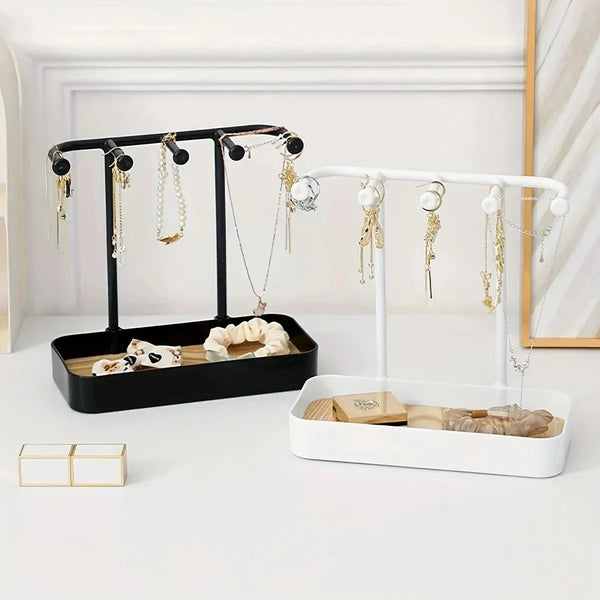 A portable jewelry display rack featuring two black and white stands with hanging hooks and a drawer box for displaying neckl