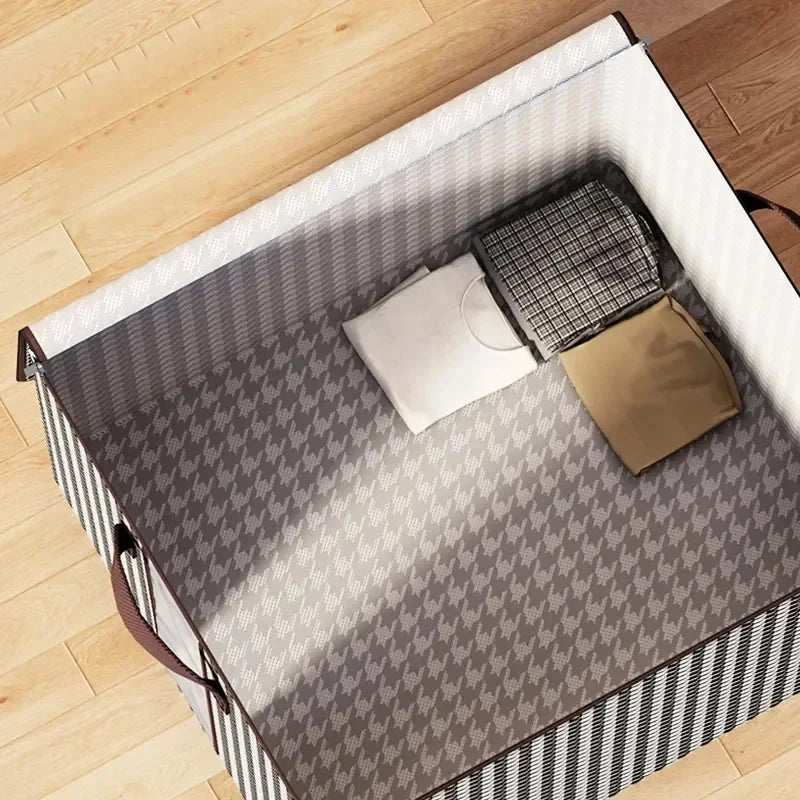 A foldable clothing storage bag with a gray and white checkered pattern is shown open on a wooden floor.