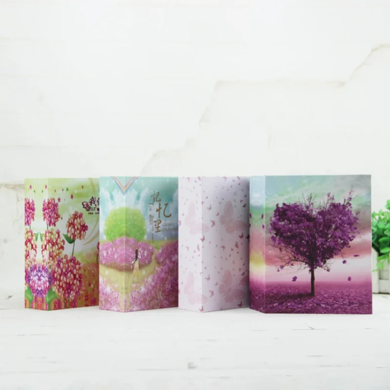 Una fila de cuatro álbumes de fotos rosa y verde con vibrantes escenas florales y de la naturaleza.