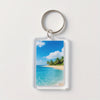 Clear acrylic keychain featuring a vibrant tropical beach scene with blue water and palm trees under a bright sky