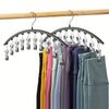 Curved metal hangers with ten clips used to organize clothing on a wooden rod.