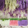 A display of artificial wisteria garlands in purple and white hanging decor