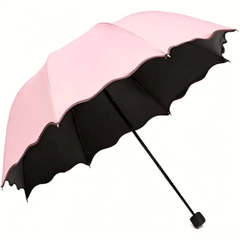 A pink and black reversible umbrella open, showing its canopy and shaft.