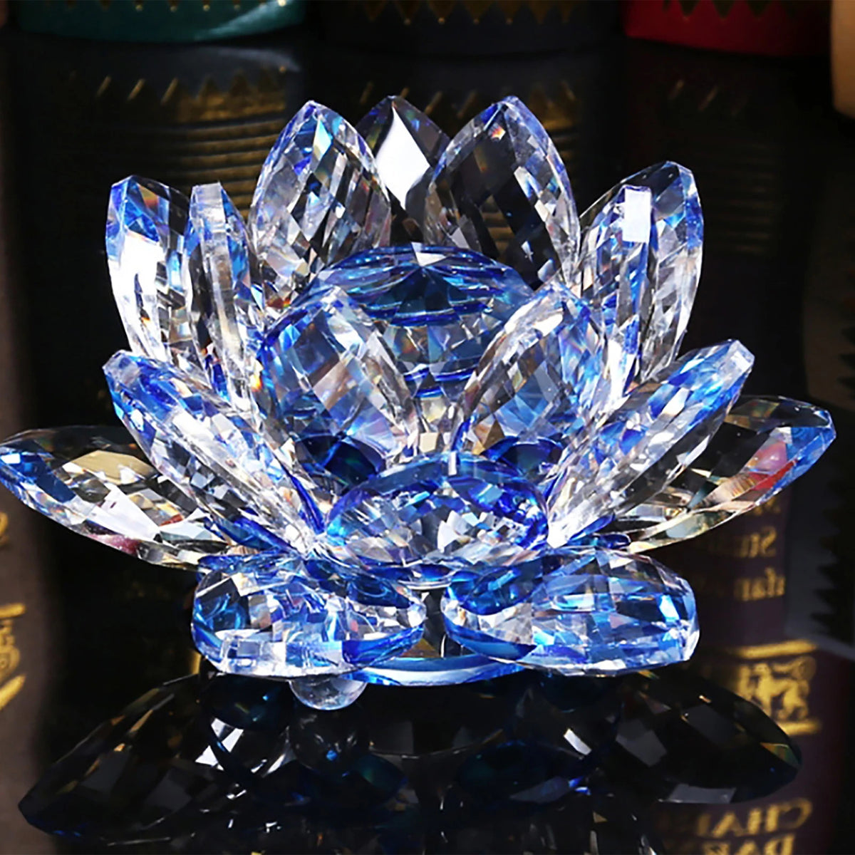 A brilliant blue crystal lotus flower centerpiece displayed on a reflective surface.