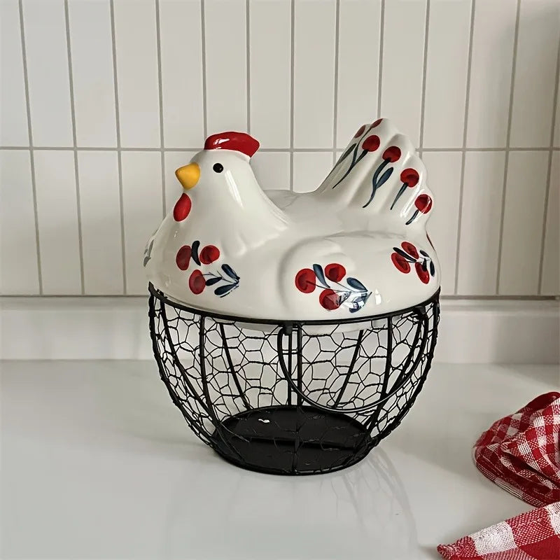 A white ceramic hen-shaped fruit basket with red and blue accents sits on a white surface.