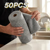 A person is holding a roll of gray microfiber cleaning wipes, packaged in a 50-pack.