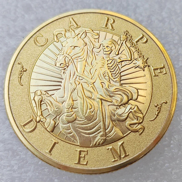 A gold-colored coin featuring a profile of a horse and rider, with the word DIEM inscribed around the edge.