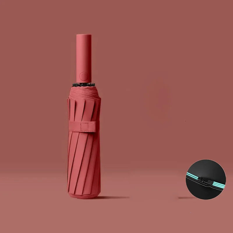 A pink heavy-duty automatic windproof umbrella with a textured handle and black cap.
