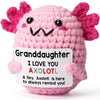 Handmade pink crochet axolotl figurine with black eyes and pink gills