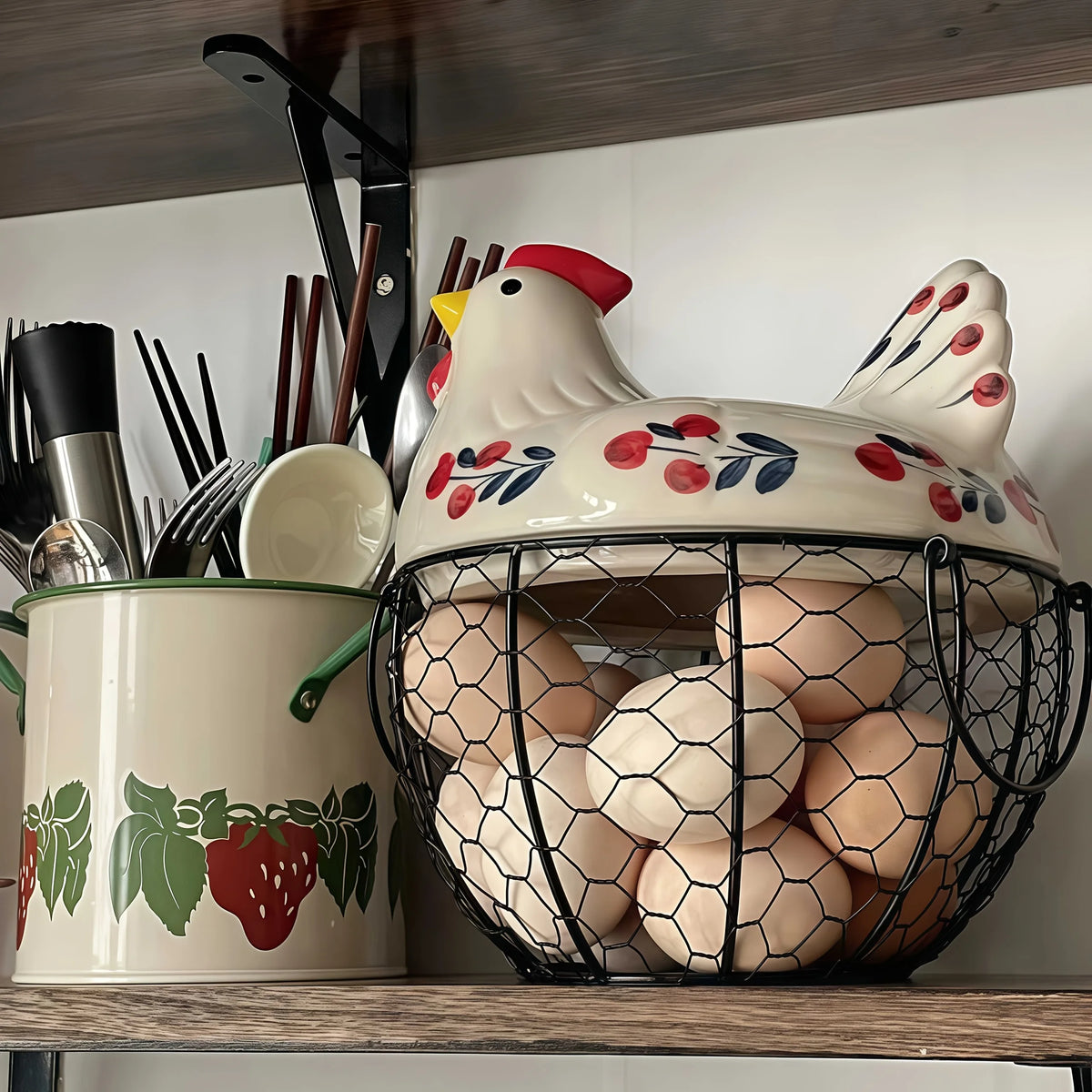 A rustic ceramic hen-shaped fruit basket filled with eggs and various kitchen utensils on a wooden shelf.